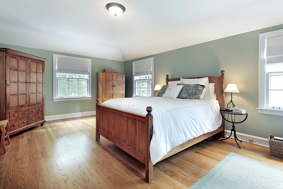 Accessible bedroom with warm wood tones, remodeled by Jeff of Paradise Found Construction to support aging in place. Wide pathways and functional layout.